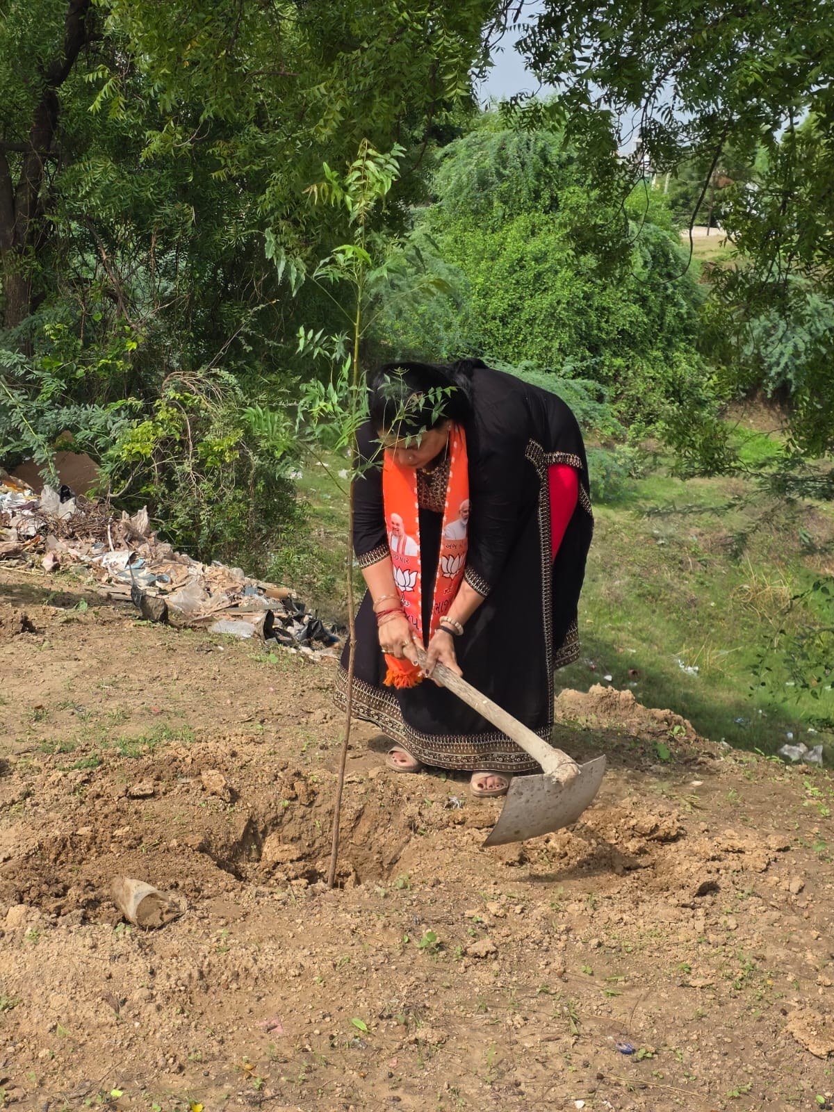 Community members nurturing young trees